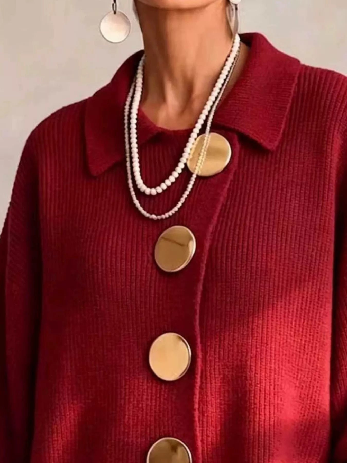 Close up of the deep red cardigan collar and large gold buttons