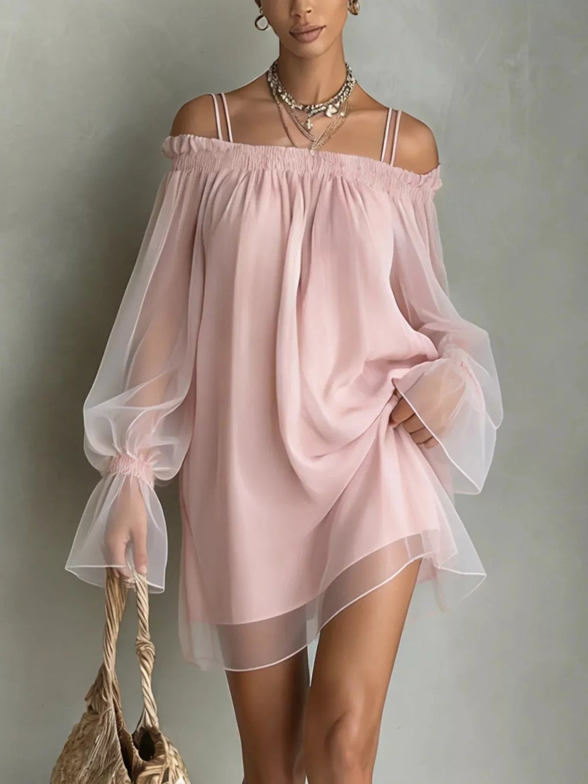 Front view of a dusty pink off shoulder mini dress with sheer long sleeves and thin straps