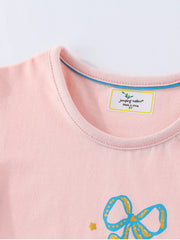 Close view of the pink children's tee neckline showing neat stitching and a blue inner trim