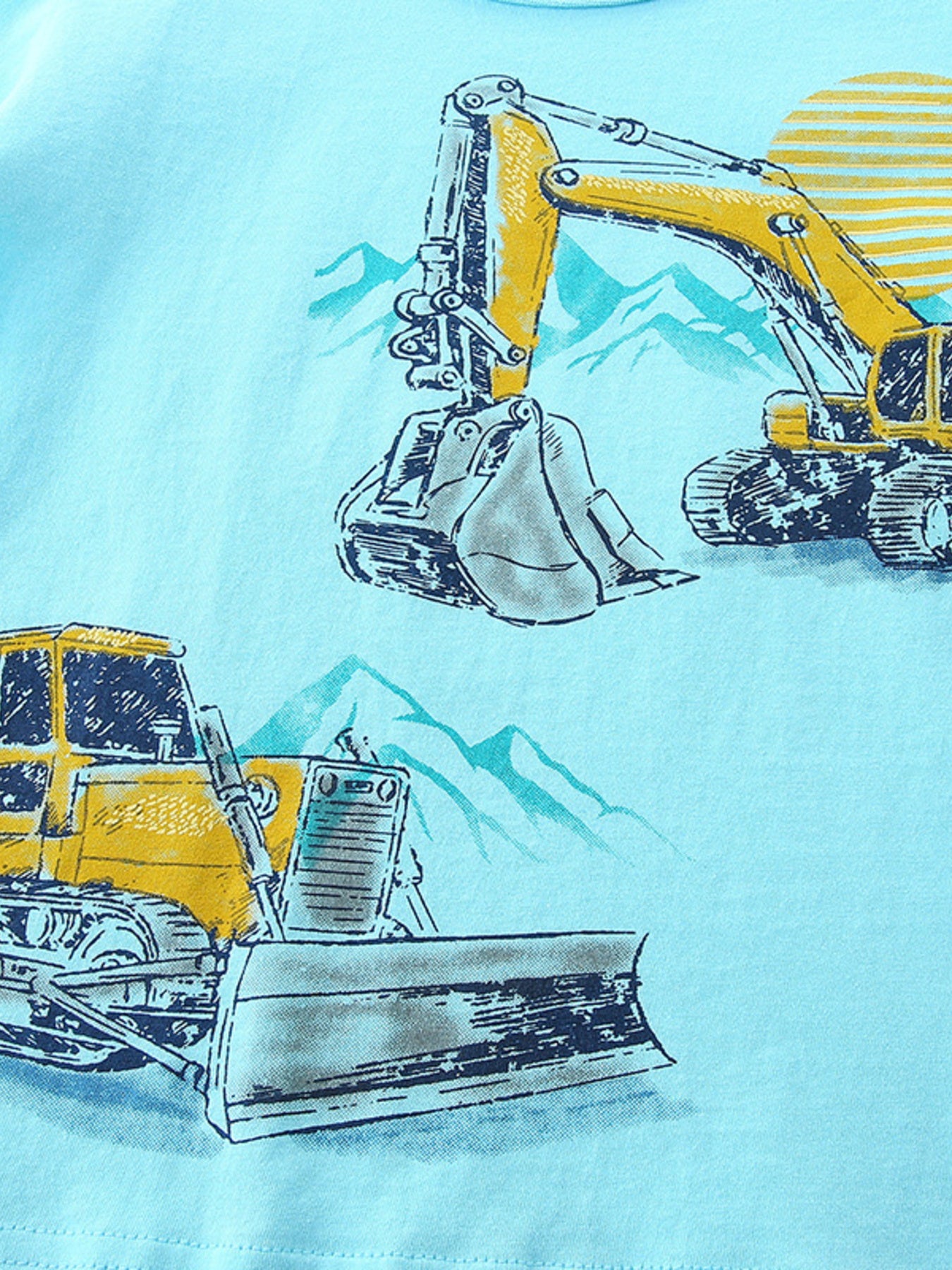 Close view of the yellow excavator and bulldozer print with mountain details on pastel blue fabric