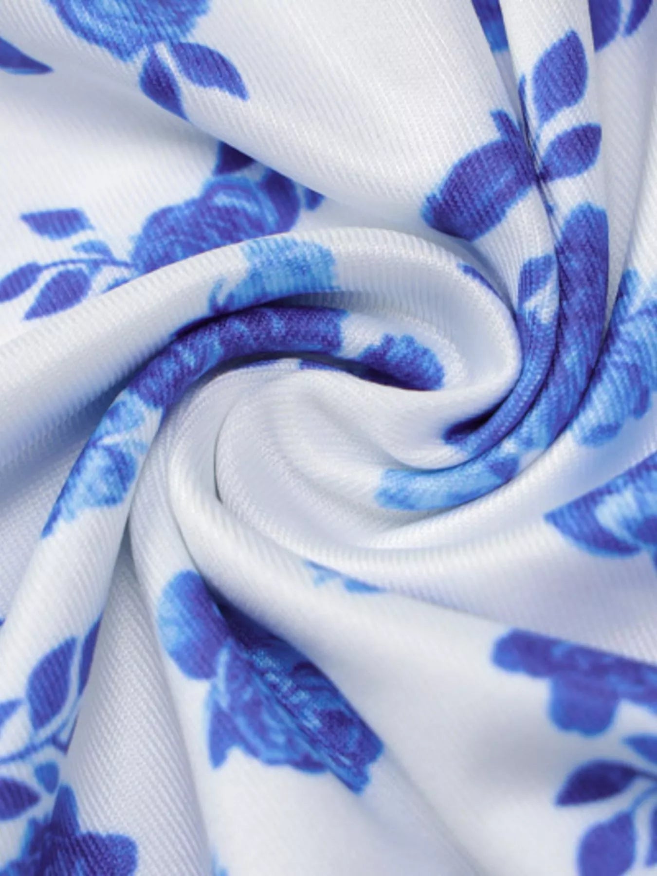 Close up of swirled blue floral print fabric showing texture of bodycon maxi dress