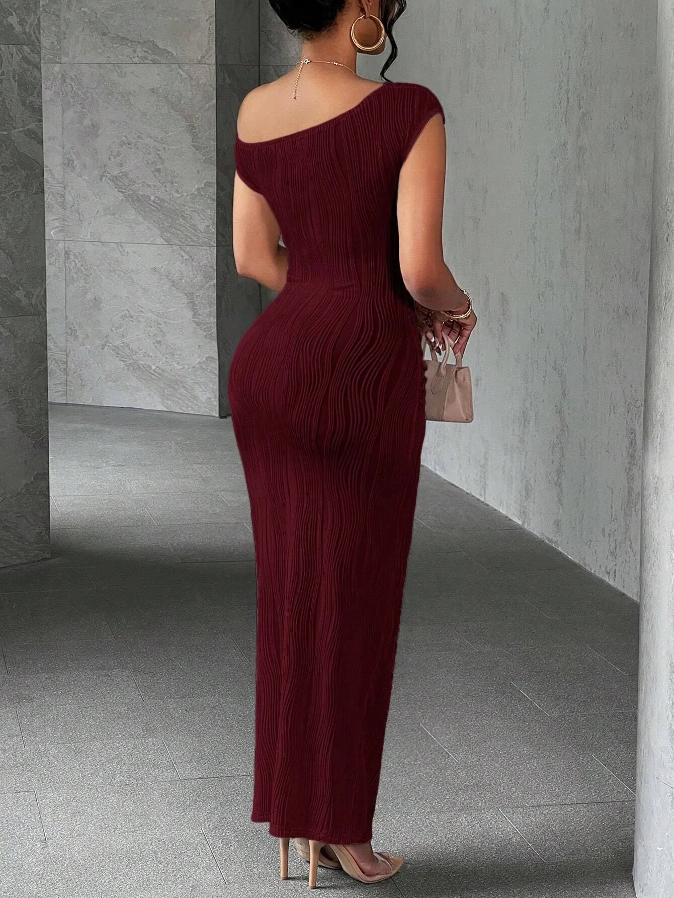 Back view of a burgundy asymmetrical one shoulder ribbed bodycon maxi dress