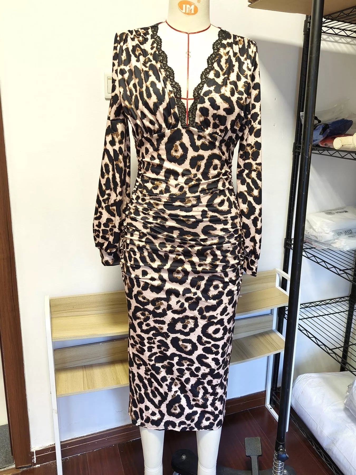 Front view of white leopard print bodycon midi dress on a mannequin
