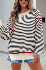On-model front view of the black and cream striped oversized sweater with drop shoulders