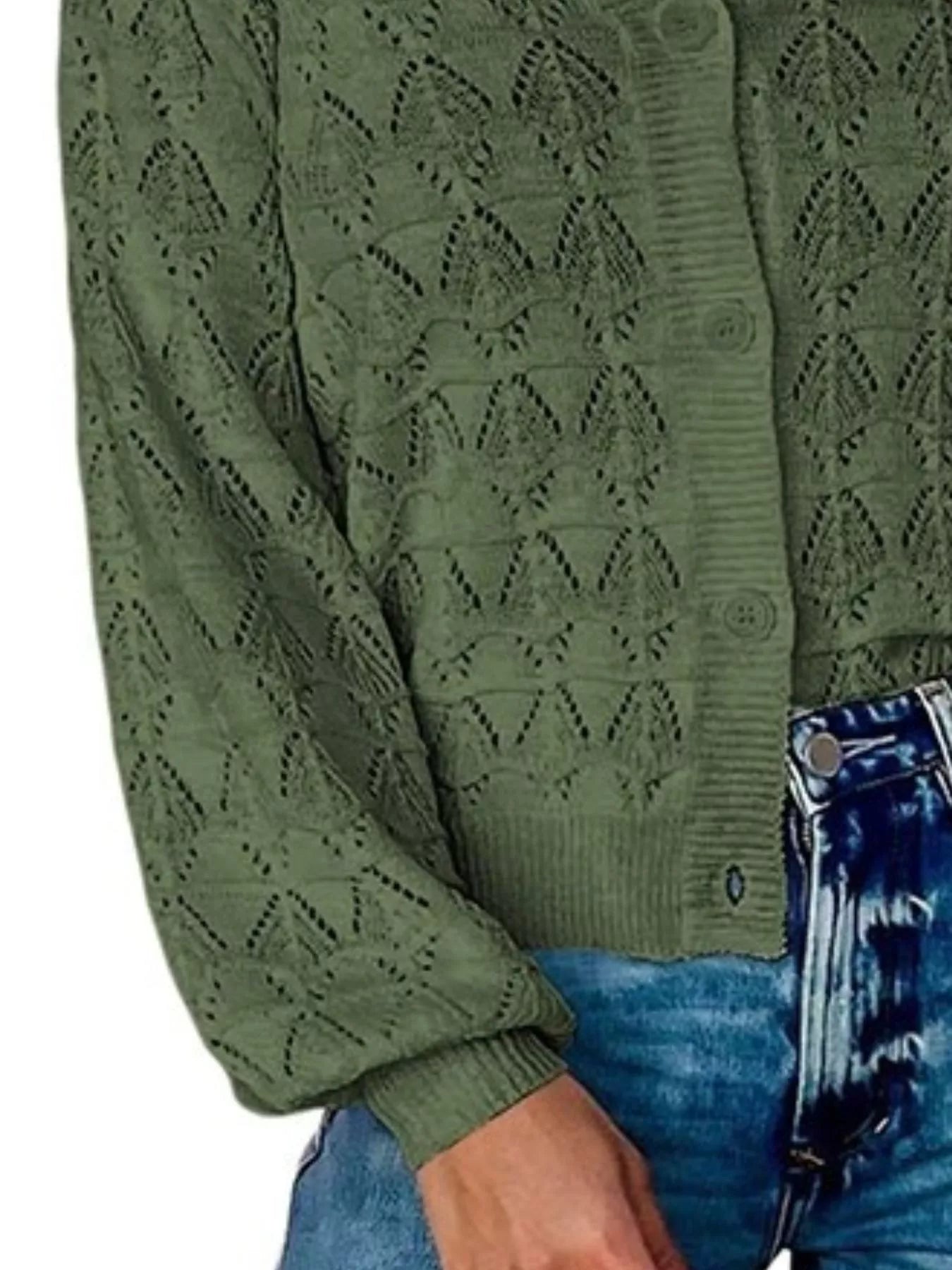 Side close view of green openwork knit cardigan showing button front and hem.