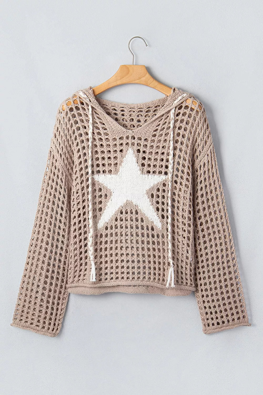 Mocha openwork crochet hooded cover up with white star and drawstrings hanging on a hanger.