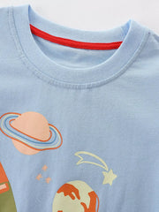 Close-up of the light blue children's tee neckline with red trim and planet graphic
