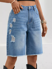 Women's ripped denim shorts with frayed hems and pockets.
