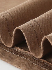 Close-up of caramel children's t-shirt folded hem stitching and knit fabric detail