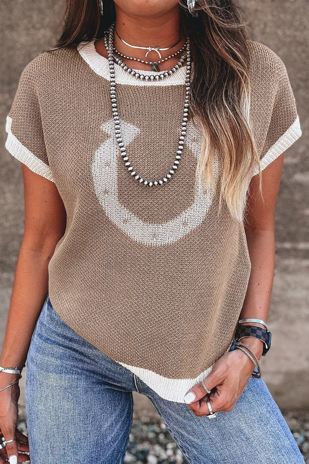 Front view of a mocha short sleeve sweater with a white horseshoe and white trim