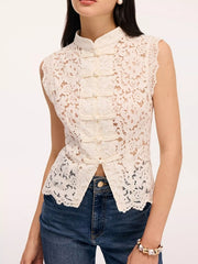 Front view of white lace sleeveless top with knot buttons and mandarin collar on model