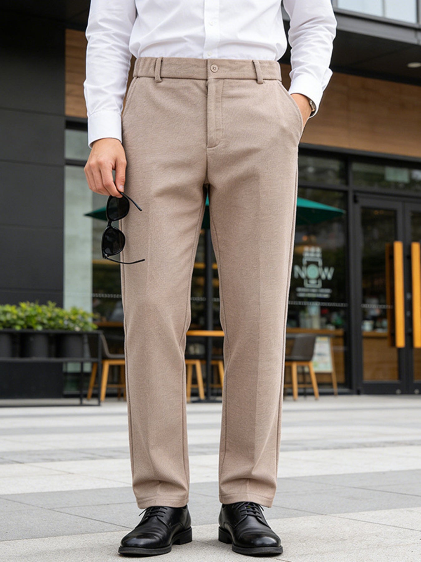 Men's khaki dress pants with a classic fit and pockets.