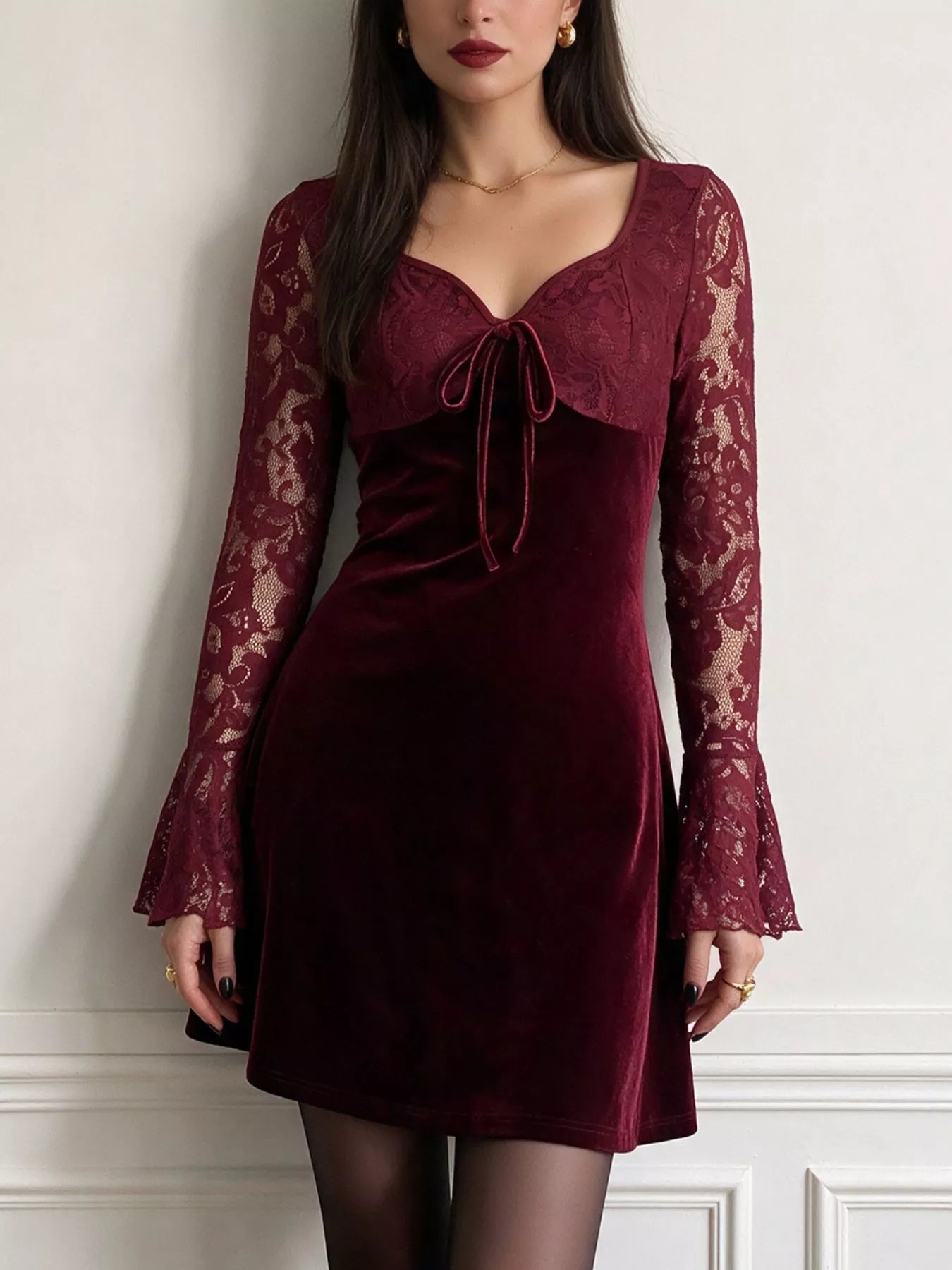 Standing front view of burgundy lace mini dress with flared lace sleeves
