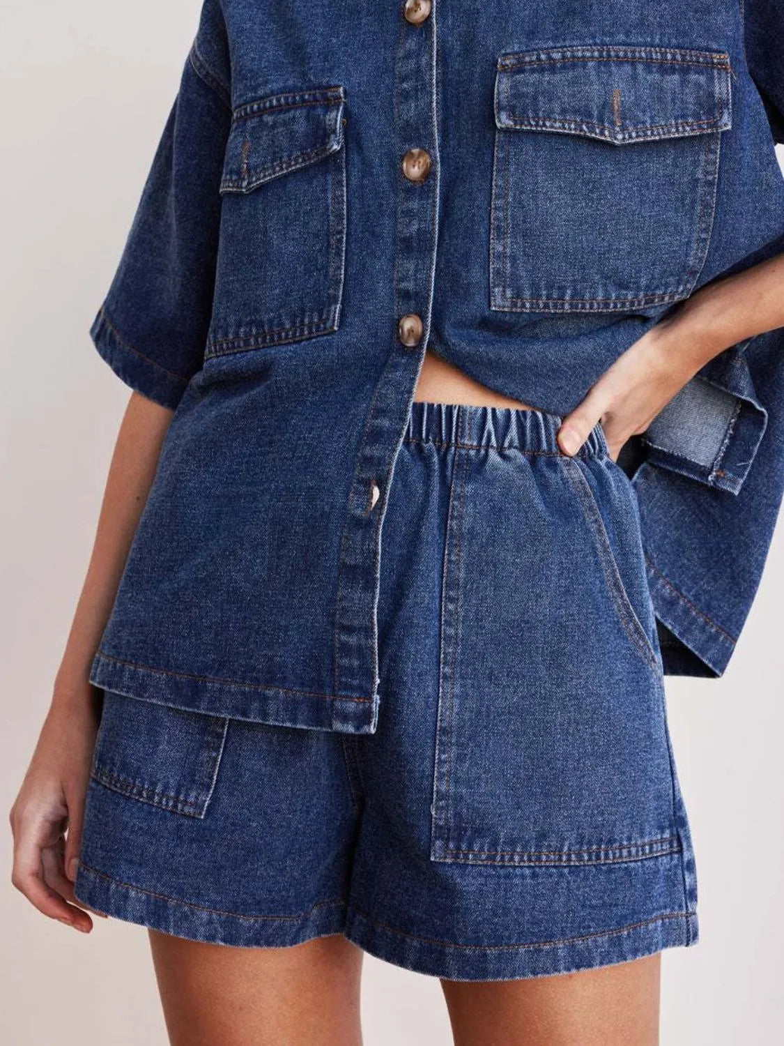 Women's denim shorts with an elastic waistband, drawstring, and pockets.