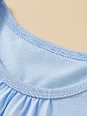 Close-up of the ribbed round neckline and gathered front on a pastel blue children's tee