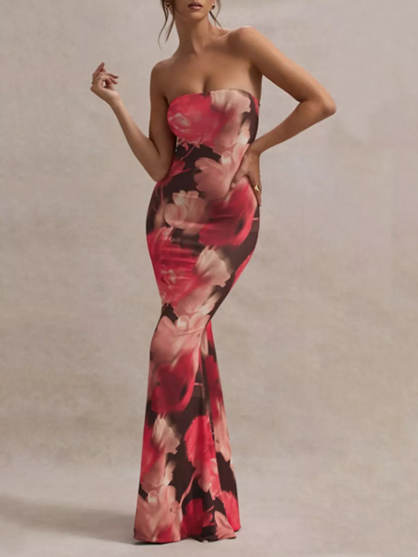 Model wearing strapless dark brown and red floral tube maxi dress, front view with hand on hip