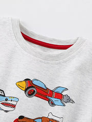 Close-up of the light gray crew neckline with red inner trim above a red rocket car print