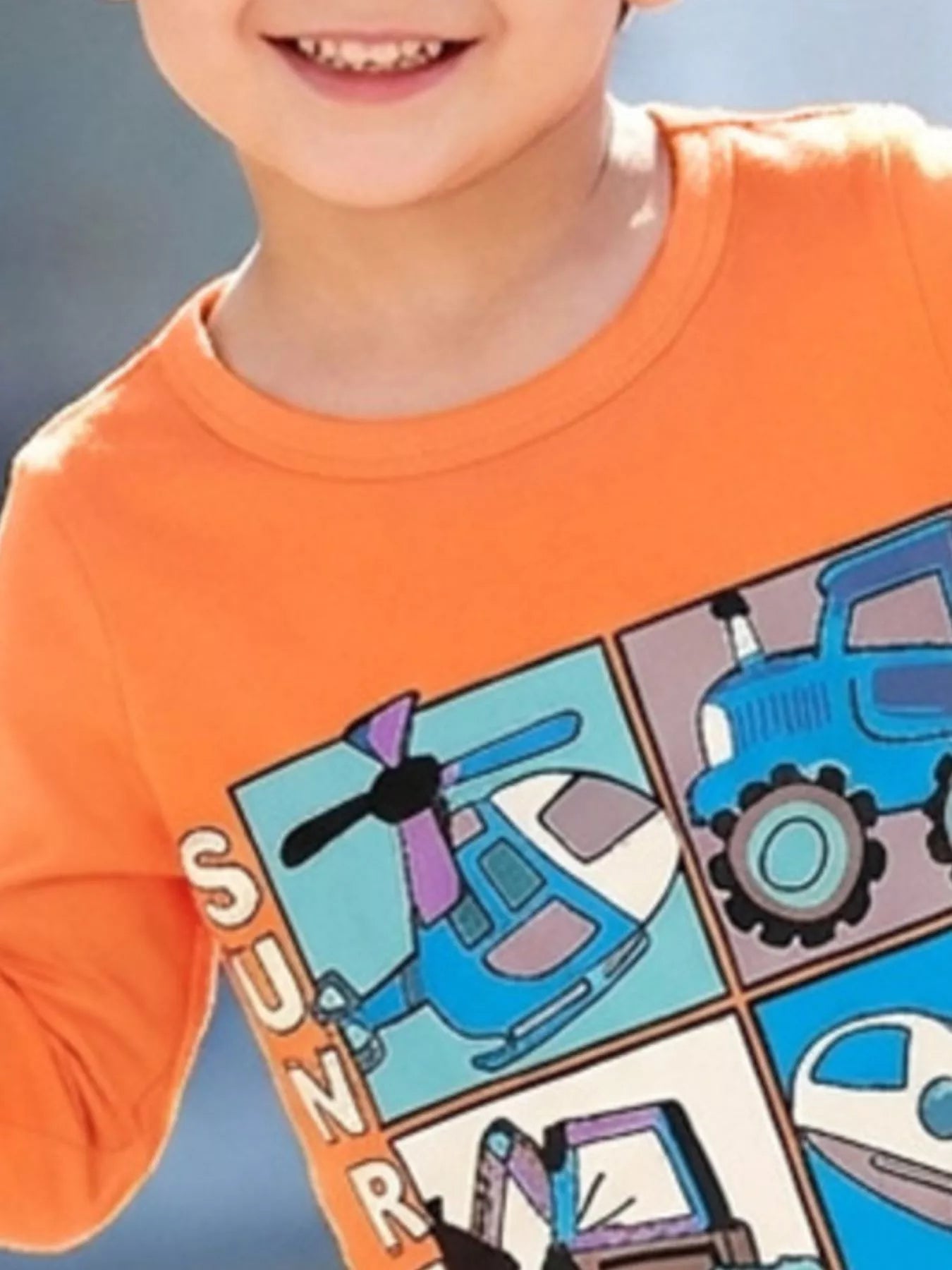 Close up of the round neckline and upper vehicle panels on a children's orange long sleeve tee