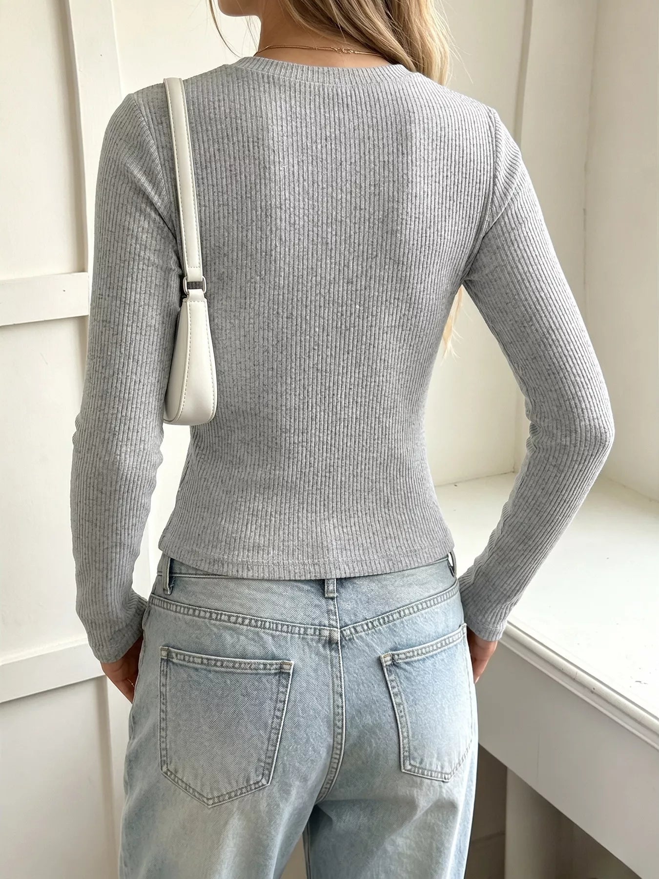 Back view of gray ribbed long-sleeve Henley T-shirt with a fitted silhouette.