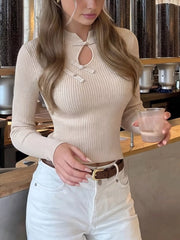 Cream ribbed knit top with knot button detail and keyhole neckline, front view indoors