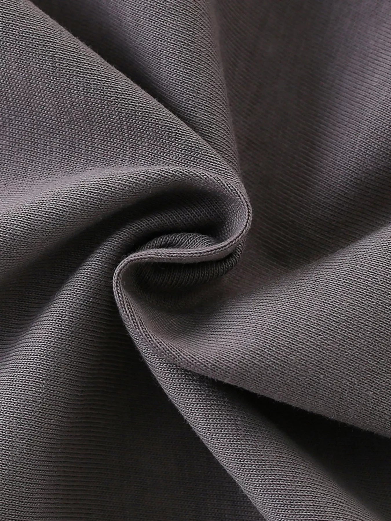 Close view of the soft dark gray fabric texture of a children's t shirt
