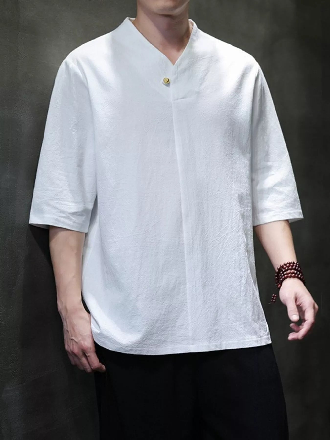 Men's solid-color buttoned shirt with three-quarter-length sleeves.