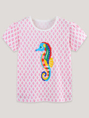 Flat front view of the blush pink children's tee with a large colorful seahorse print