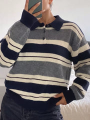 On-model front view of a navy, gray, and cream striped long sleeve sweater with a polo collar