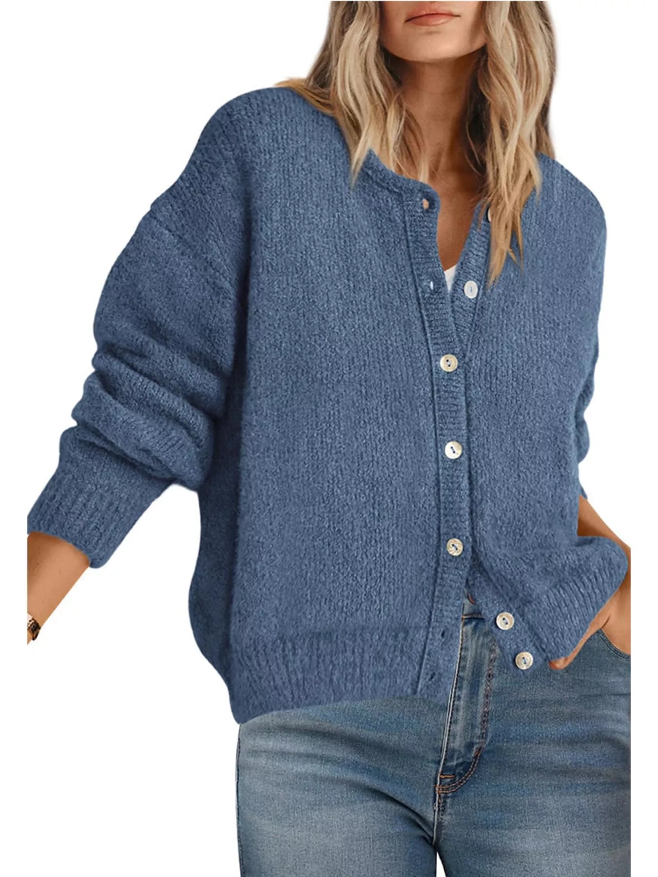 Front view of haze blue button down cardigan with white buttons worn with blue jeans