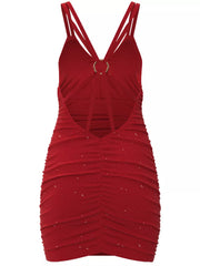 Flat back view of red glitter ruched mini dress with open back and ring strap detail