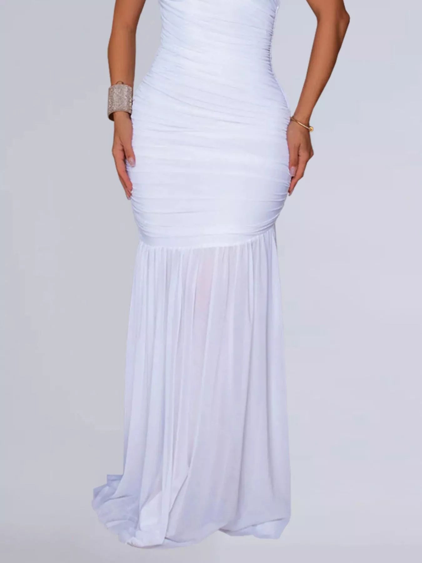 Lower view of white ruched bodycon maxi dress showing the flowing skirt