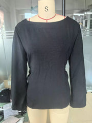 Front view of black boat neck long sleeve slim fit top on mannequin indoors