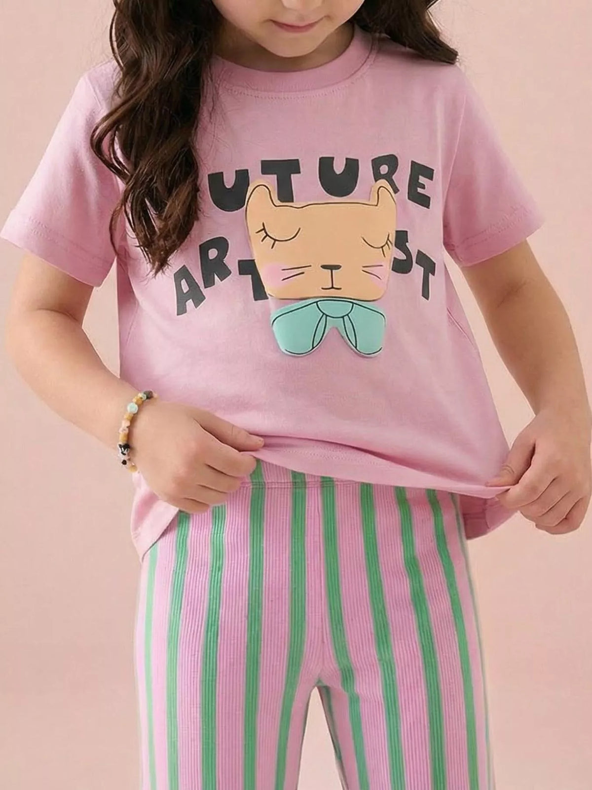 Pink children's short sleeve T-shirt shown worn with a sleeping cat face and mint bow graphic