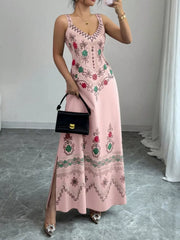 Dusty pink floral sleeveless maxi dress with side slit shown from the front on model