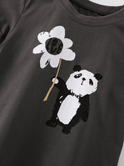 Angled close-up of the panda holding a white flower printed on dark gray fabric