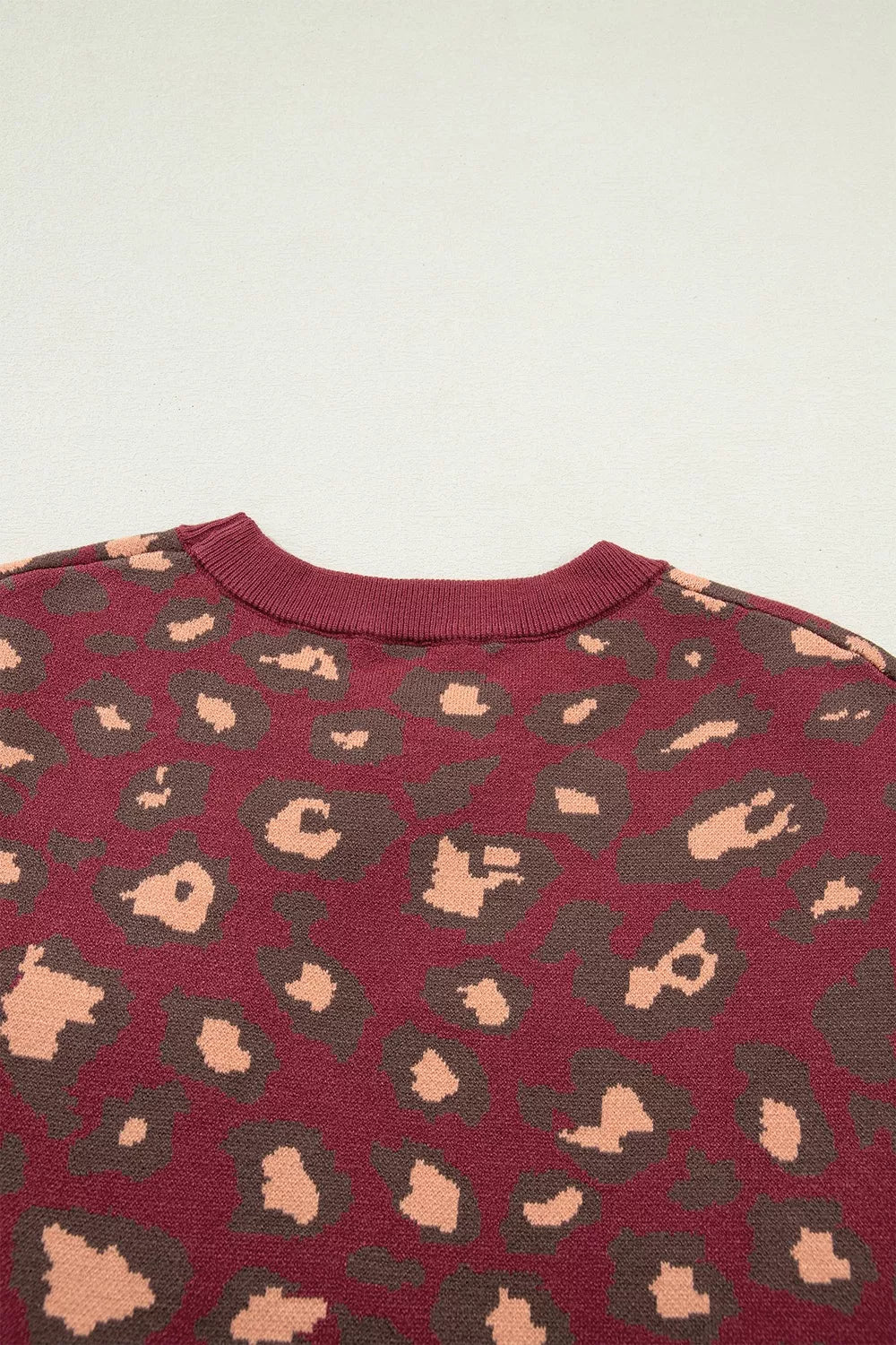 Close-up of the deep red leopard print knit top back neckline