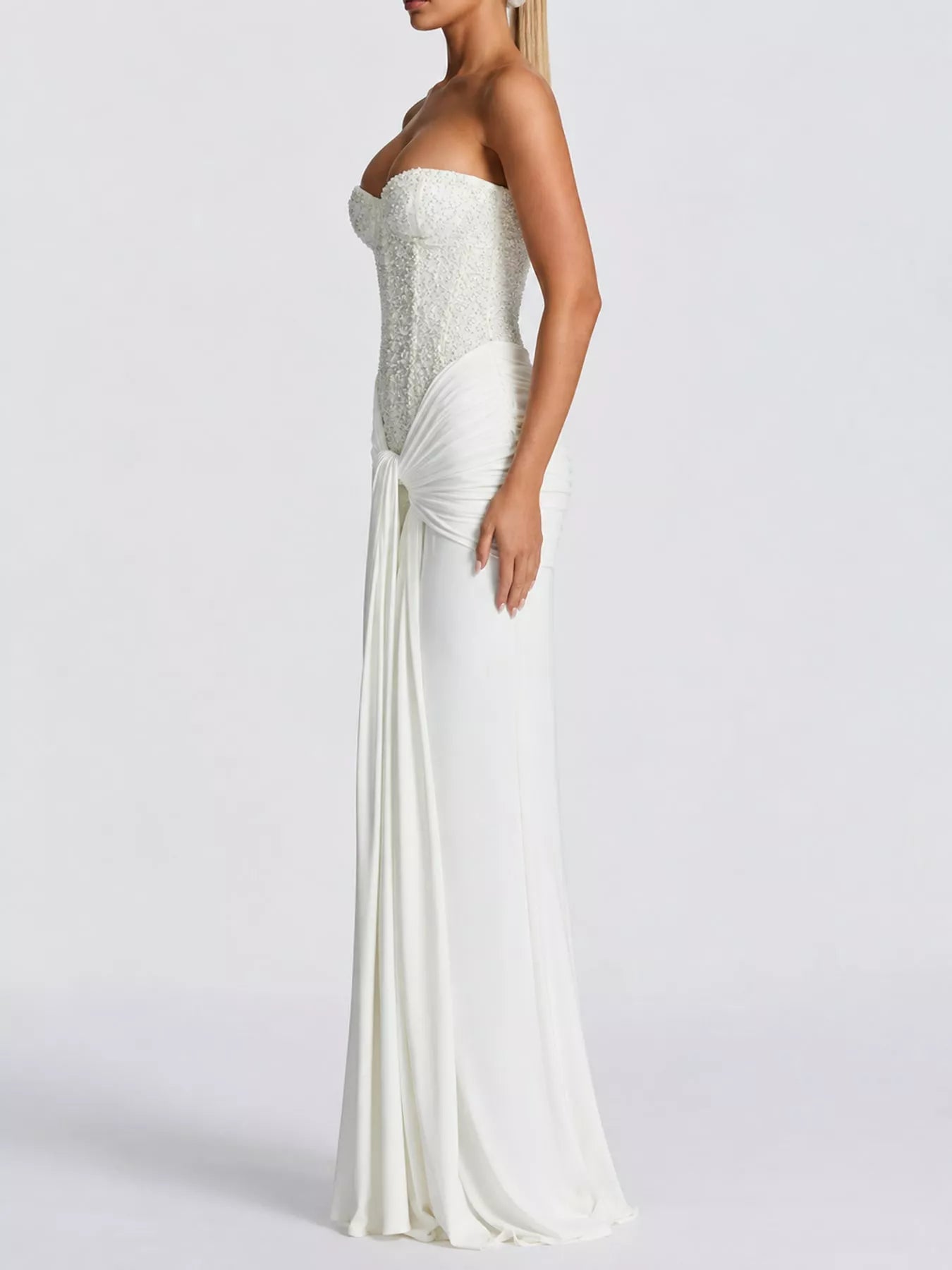White strapless sequin corset maxi dress on model, full length side profile in studio