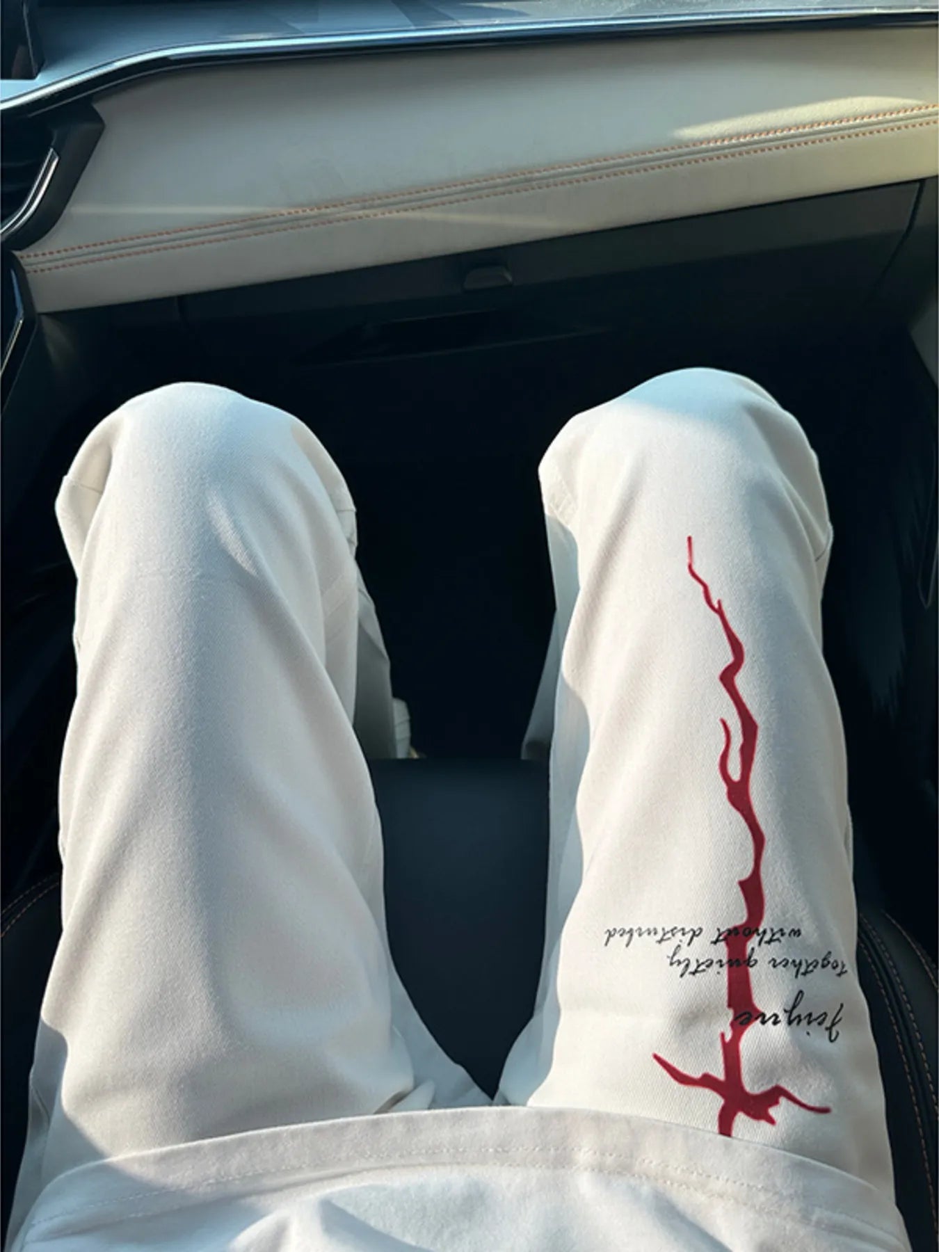 Men's white casual pants with a bootcut silhouette.