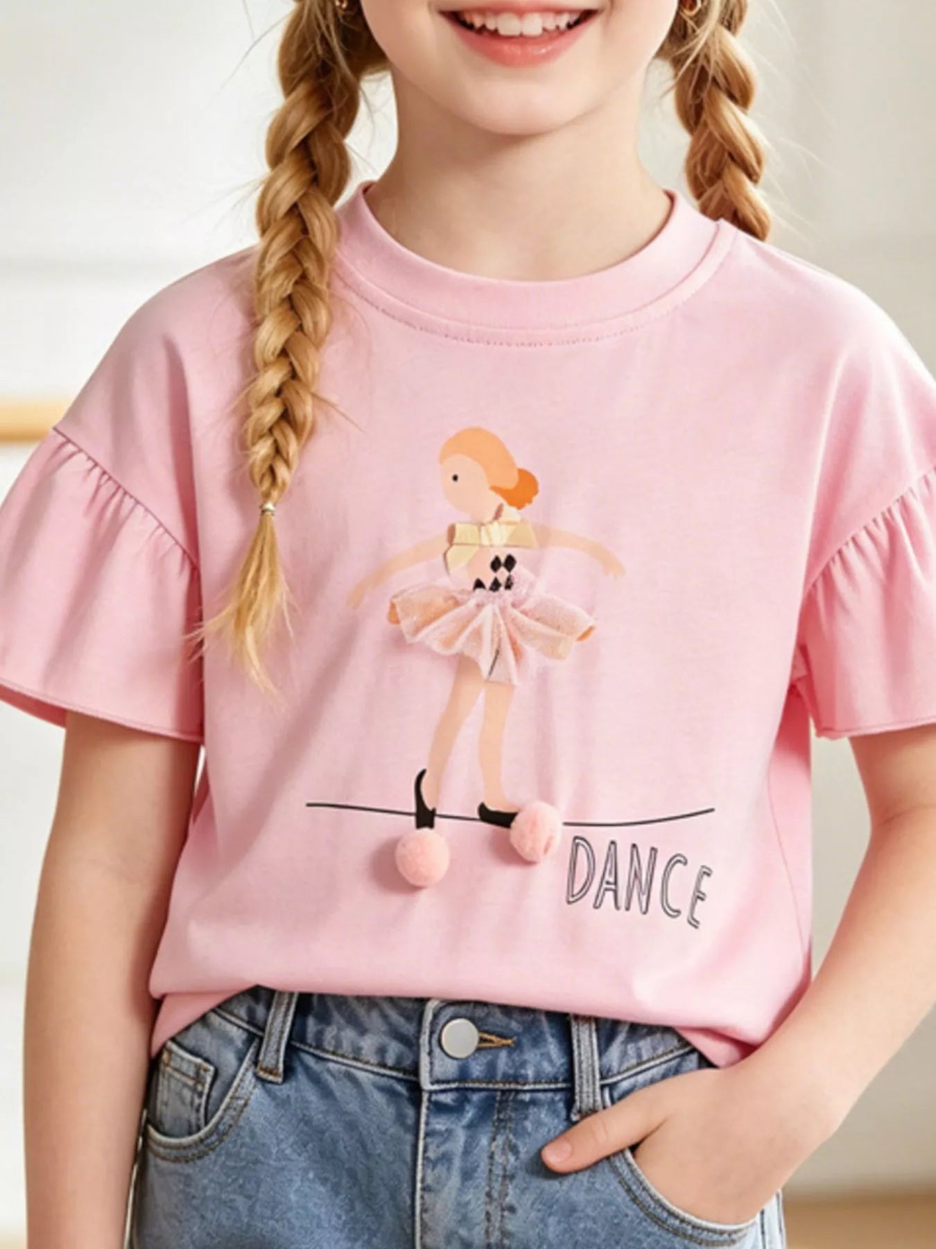 Blush pink children's t-shirt with flared sleeves and a ballet dancer graphic with tulle skirt and pom poms