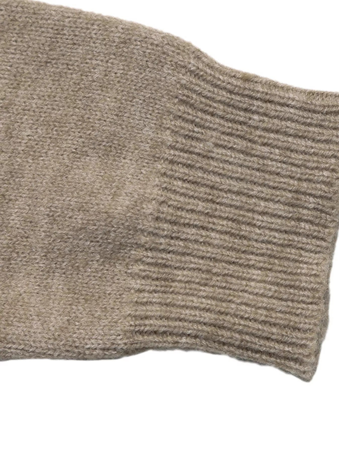 Close up of ribbed cuff on khaki dropped shoulder long sleeve sweater