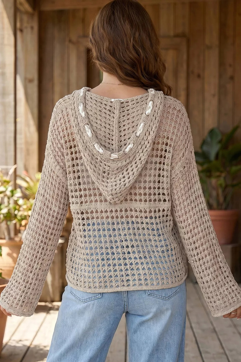 Back view of mocha openwork crochet hooded cover up showing hood and drawstring details.