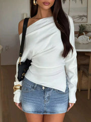 Front view of white one shoulder long sleeve top with asymmetric hem worn indoors