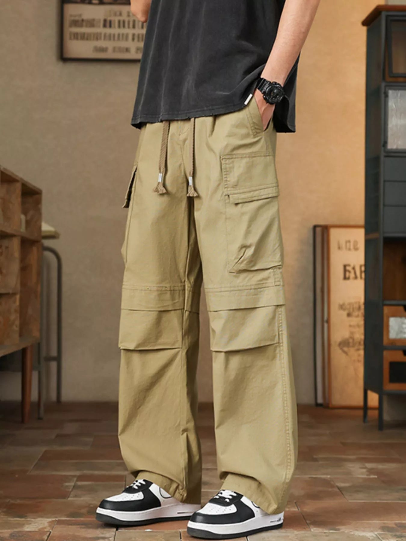 Men's relaxed fit cargo pants with a drawstring waist and pockets.