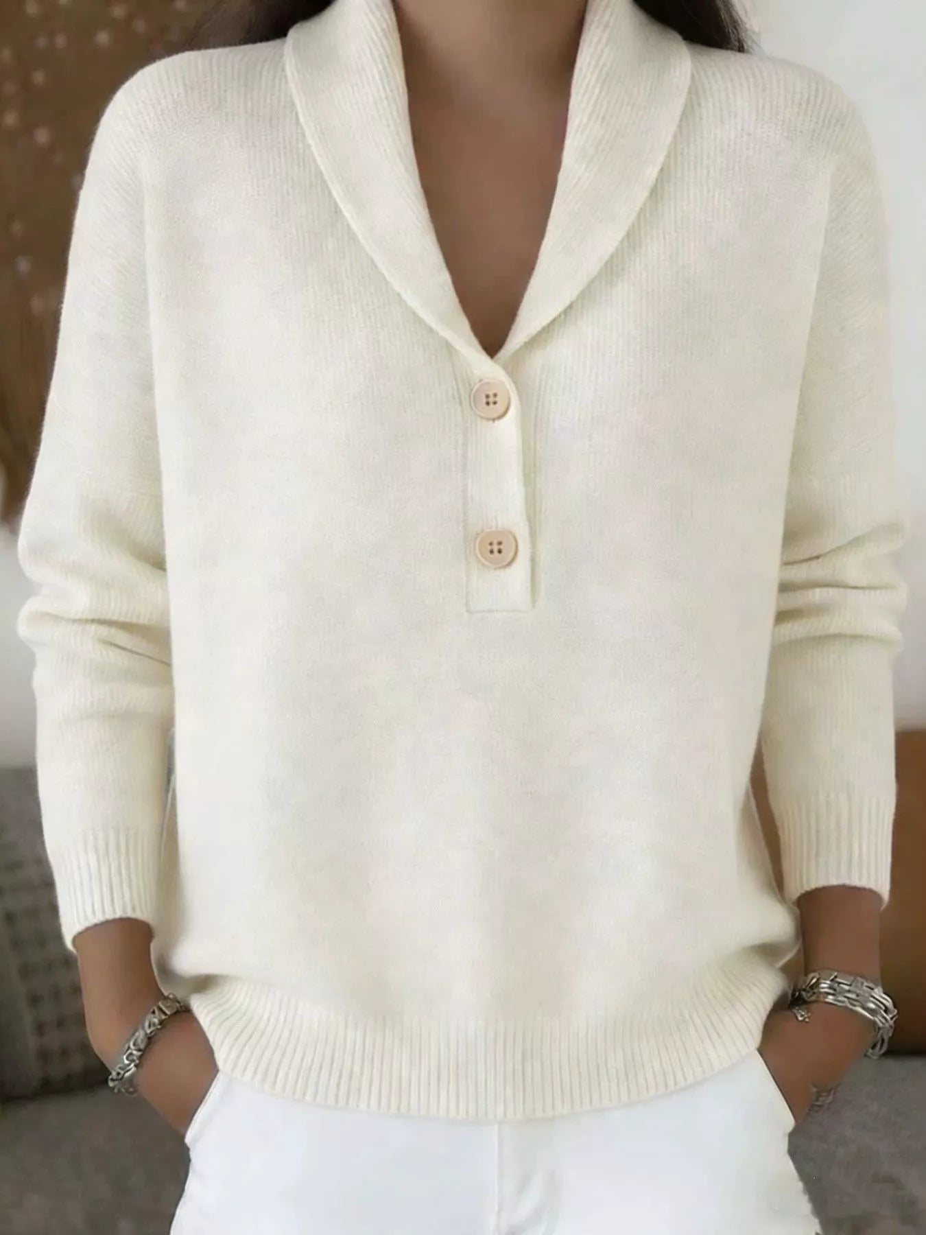 On-model front view of a cream shawl collar sweater with beige buttons