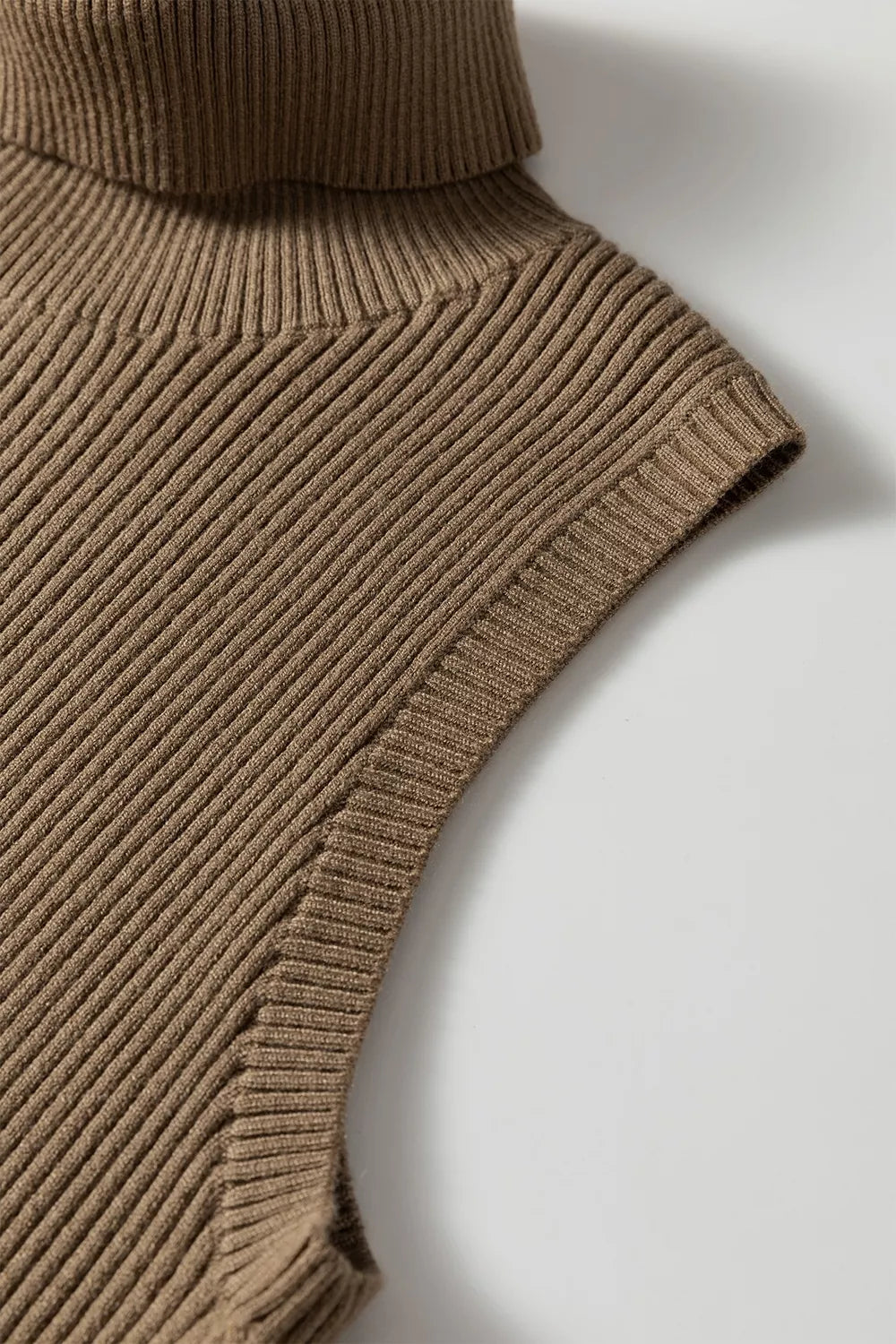 Close up of the mocha vest shoulder and ribbed armhole edge