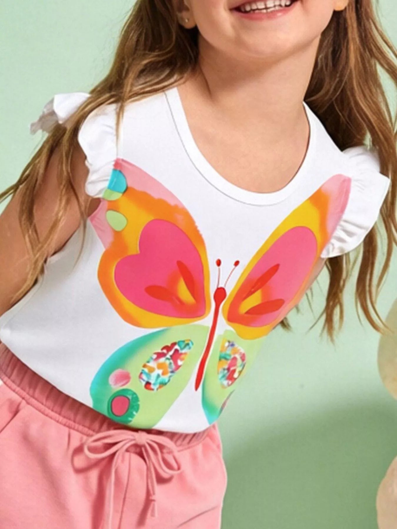 Children's white T-shirt featuring a butterfly graphic and ruffle sleeves.