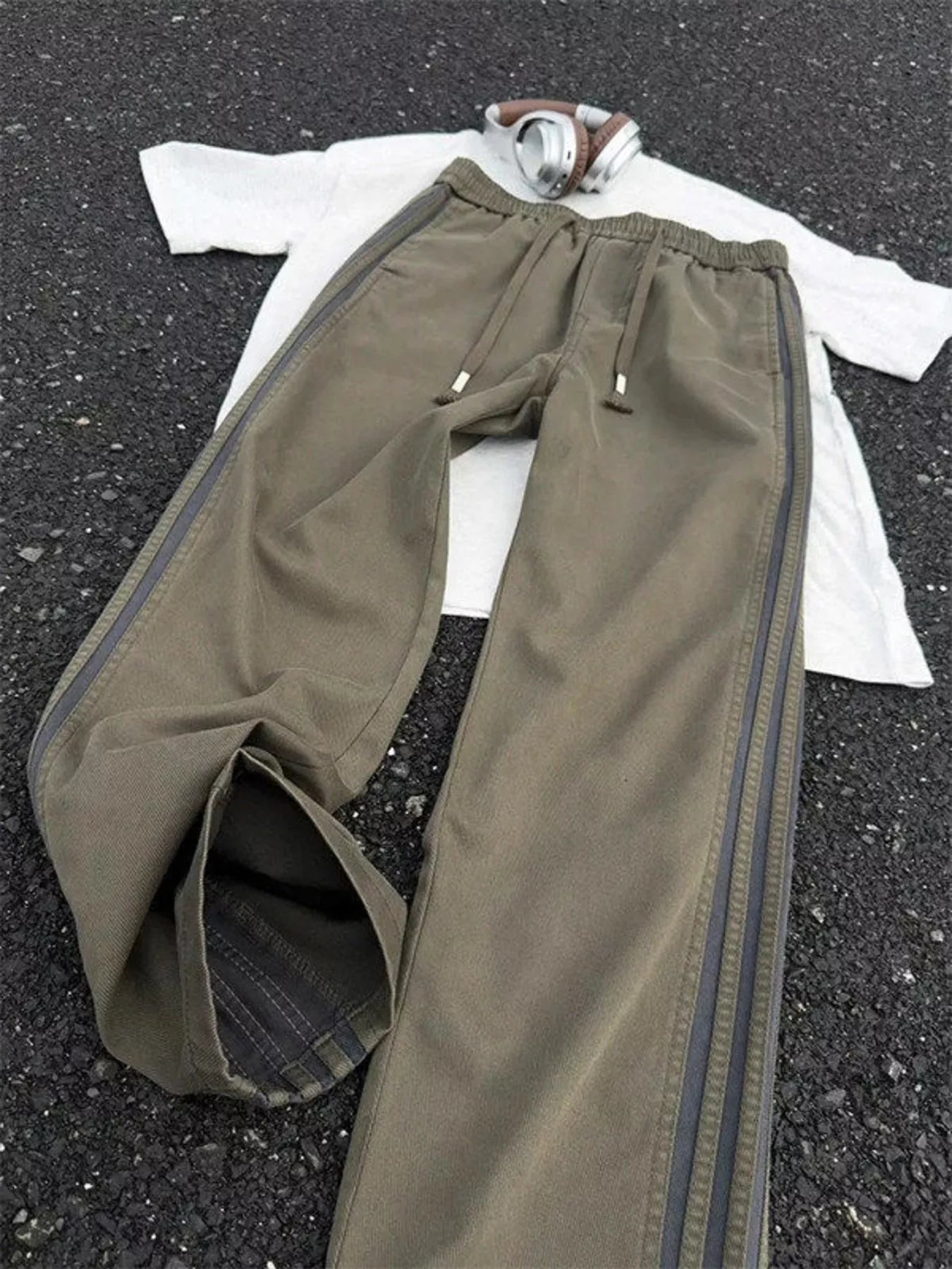 Men's striped wide leg pants with a drawstring waist and pockets.