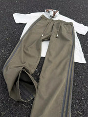Men's striped wide leg pants with a drawstring waist and pockets.