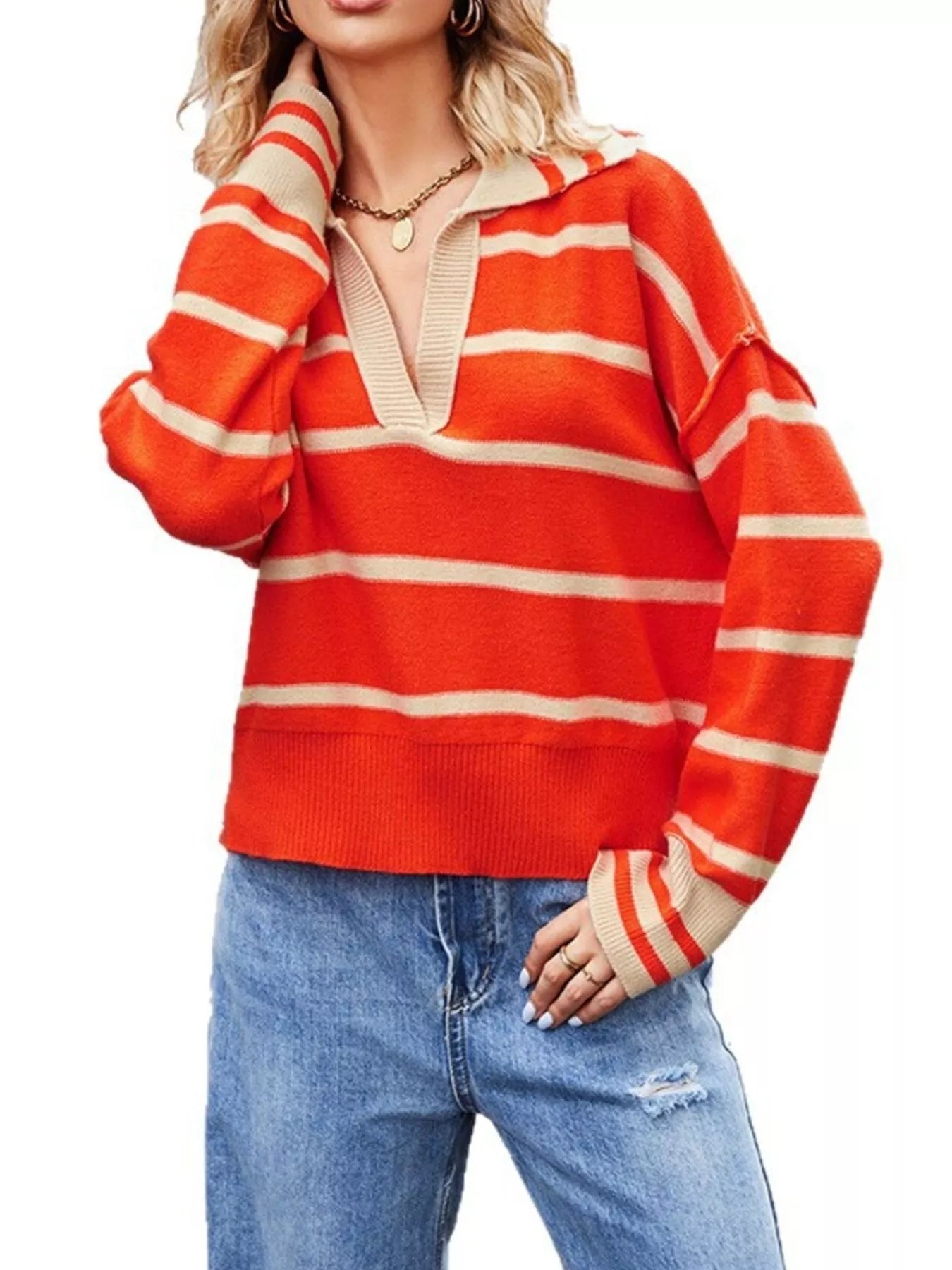 On-model front view of orange red striped Johnny collar sweater with hand raised near neck