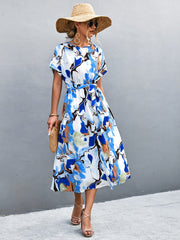 Women's blue A-line midi dress with a round neckline, short sleeves and tie waist.